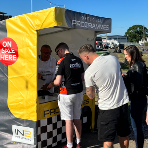 Programme stall with a queue